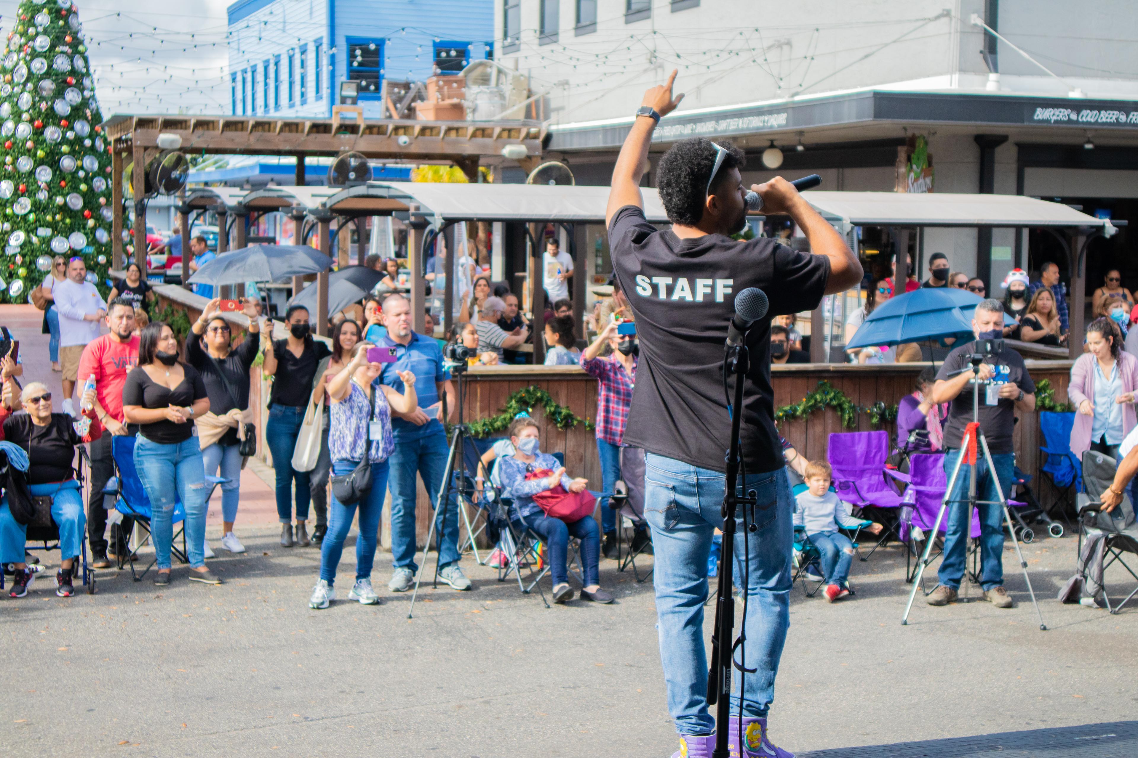 TWOM staff performing for the community at an outdoor December concert