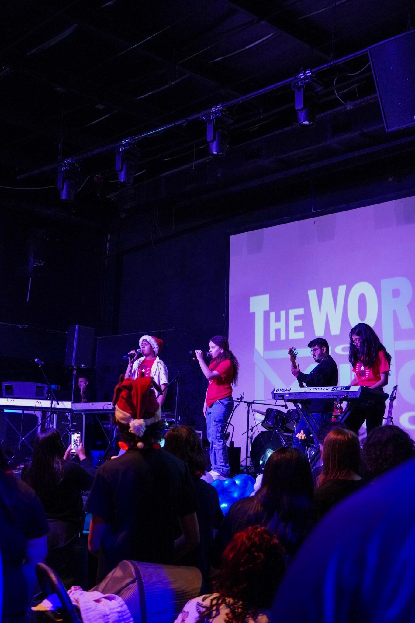 Students performing on stage at The World of Music School