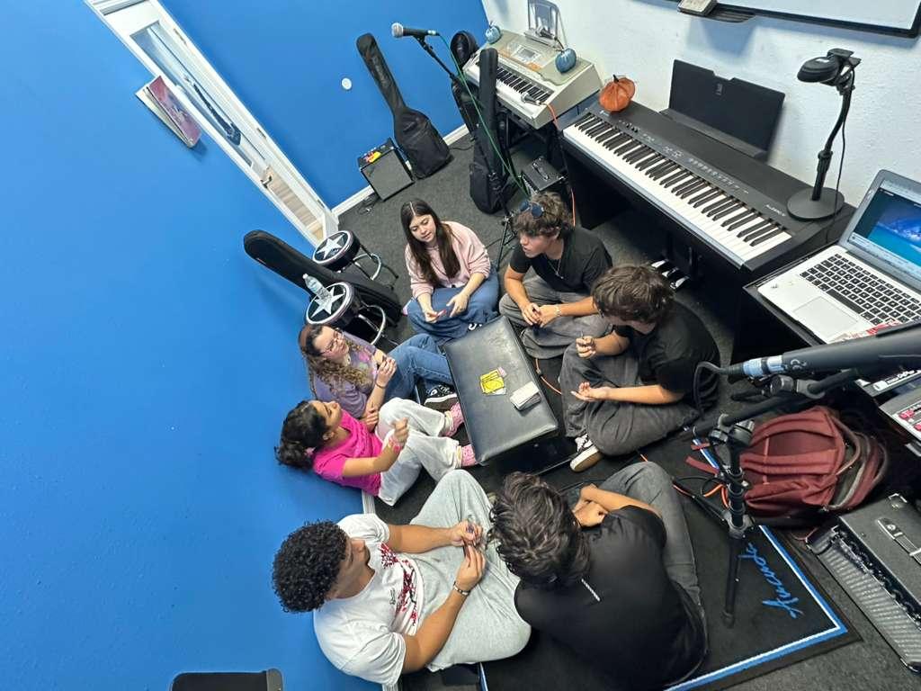 Students hanging out together in the studio between rehearsals