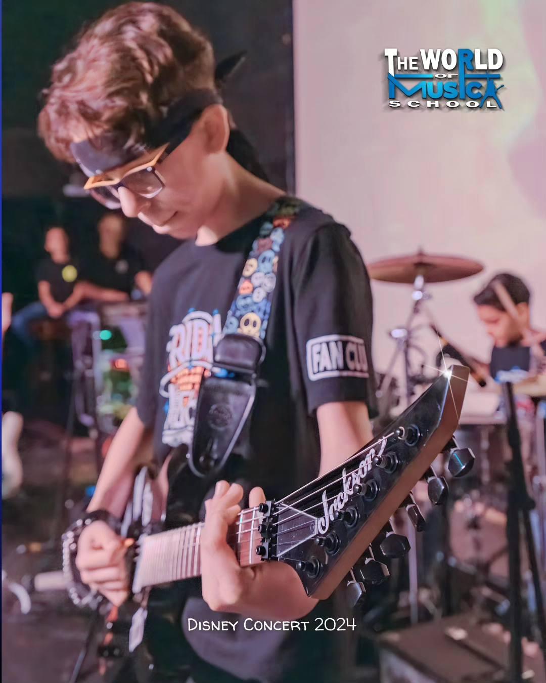 Boy playing Jackson electric guitar at Disney Concert