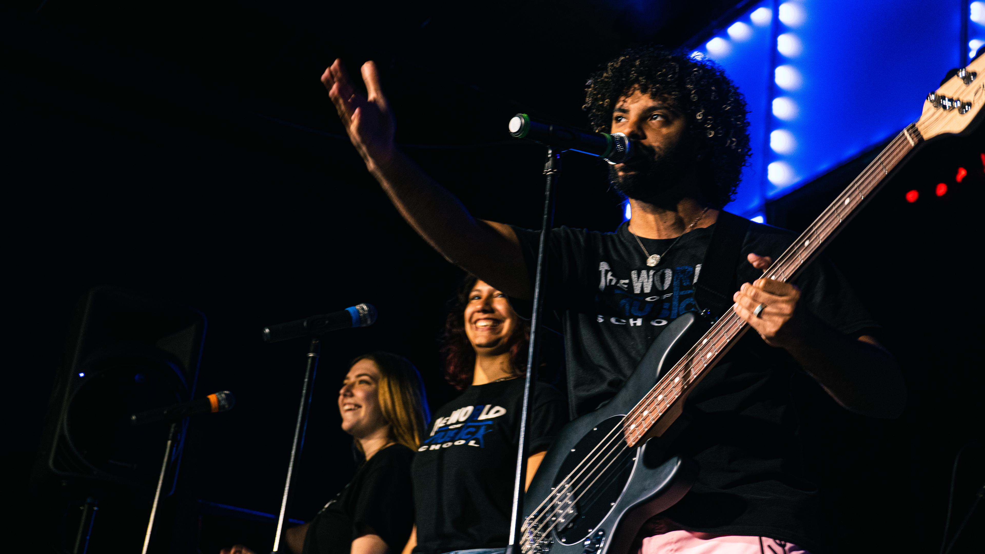 TWOM teachers performing on stage